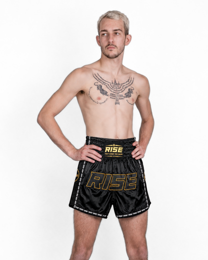 RISE 'BLACKOUT' MUAY THAI SHORTS (GOLD STITCH)